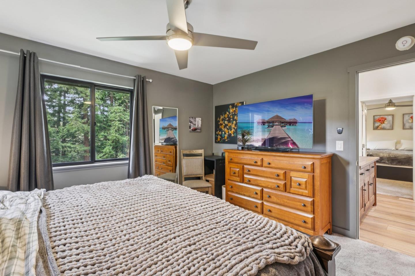 17386 Tressel Pass Road Boulder Creek, CA 95006 - Photo 15 of 41 a bedroom with a bed and wooden floor