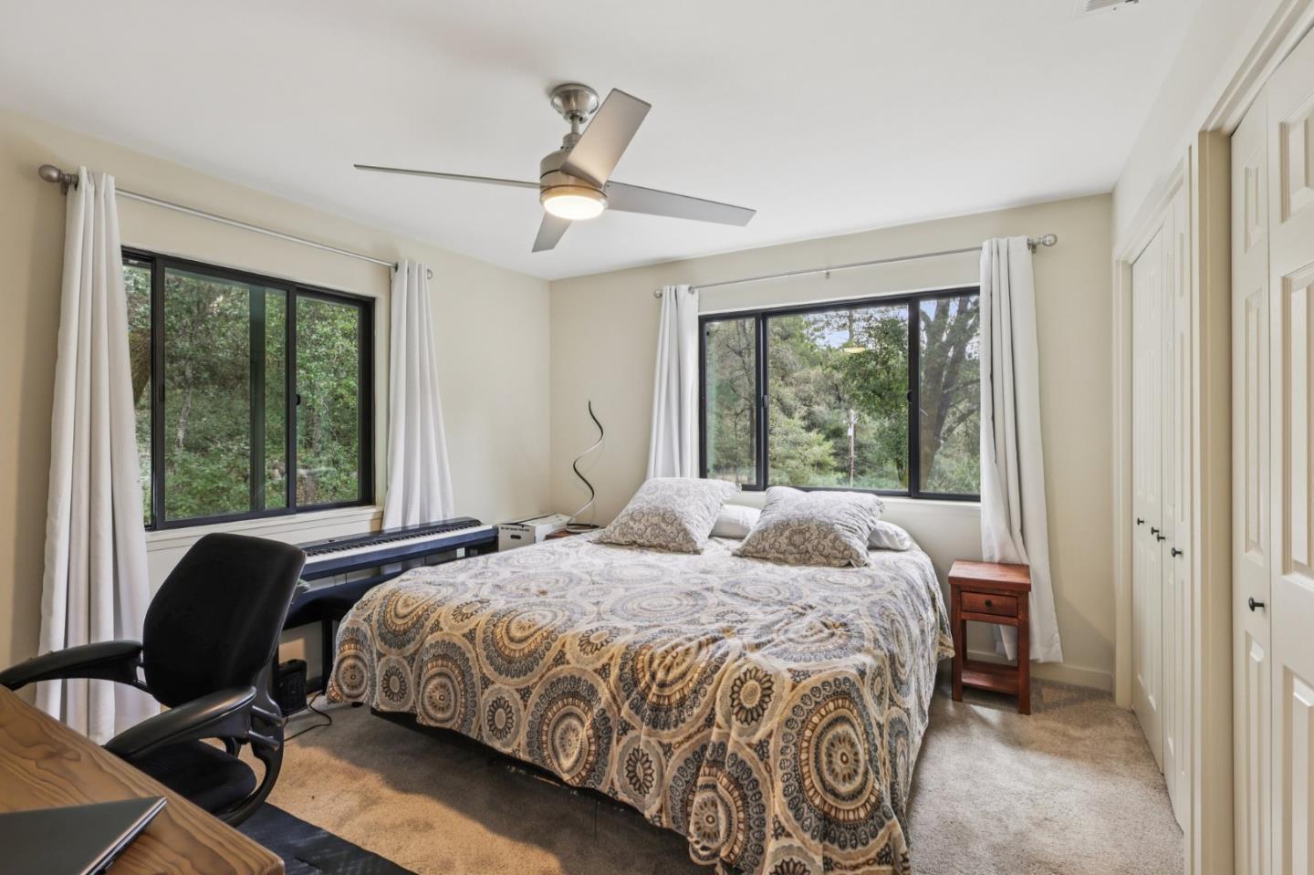 17386 Tressel Pass Road Boulder Creek, CA 95006 - Photo 20 of 41 a bedroom with a bed and a window