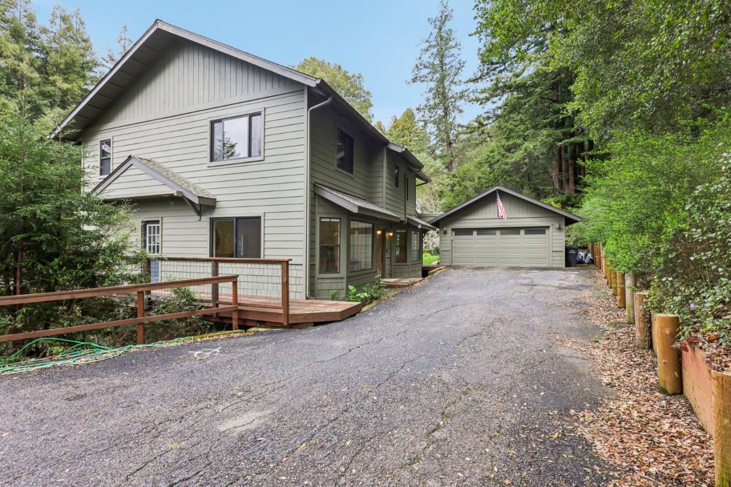 17386 Tressel Pass Road Boulder Creek, CA 95006 - Photo 2 of 41 a front view of a house with a yard and garage