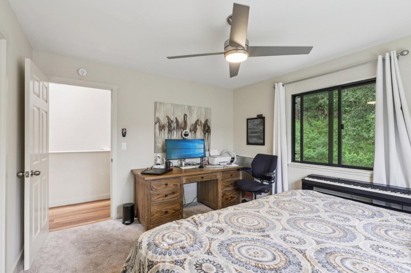 17386 Tressel Pass Road Boulder Creek, CA 95006 - Photo 21 of 41 a bedroom with a bed and a window