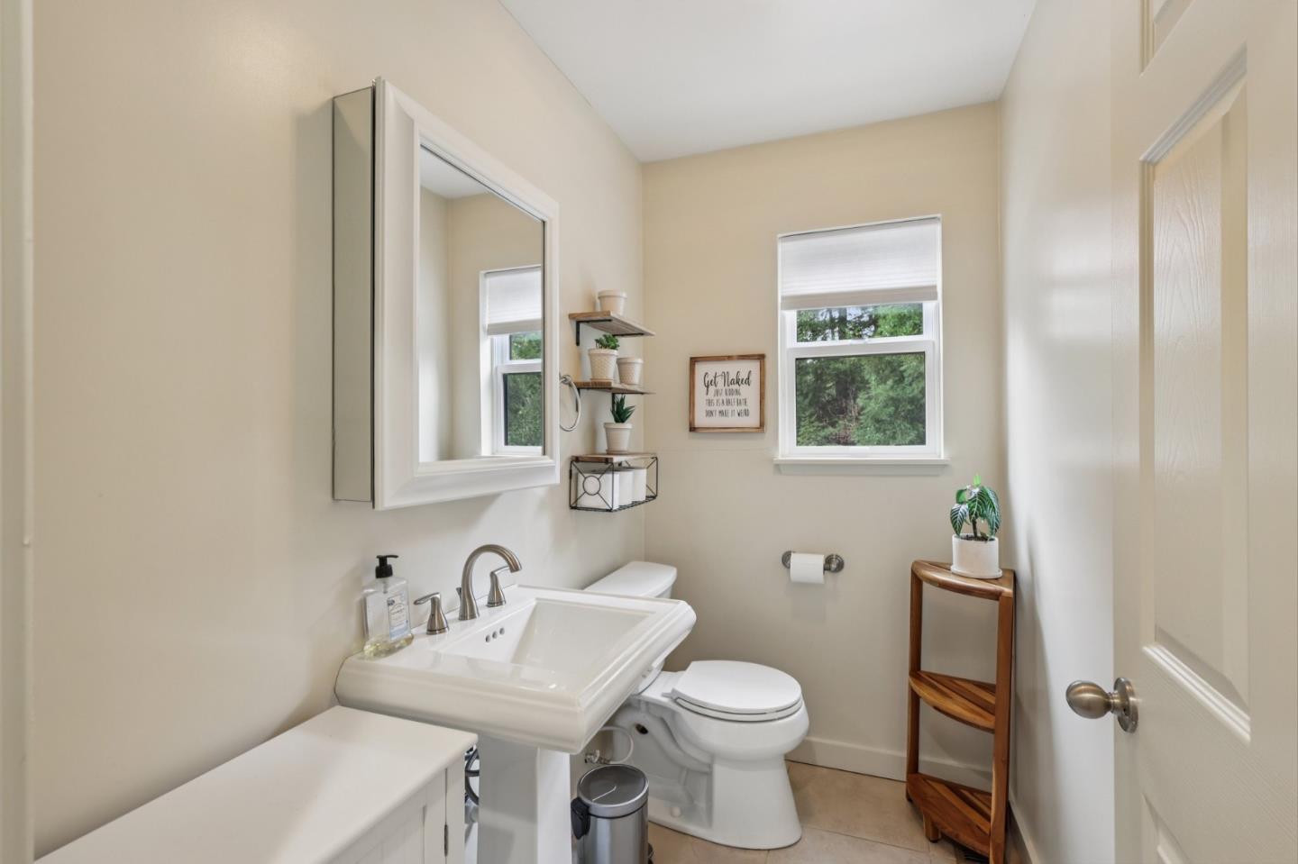 17386 Tressel Pass Road Boulder Creek, CA 95006 - Photo 25 of 41 a bathroom with a toilet a sink a mirror and a window