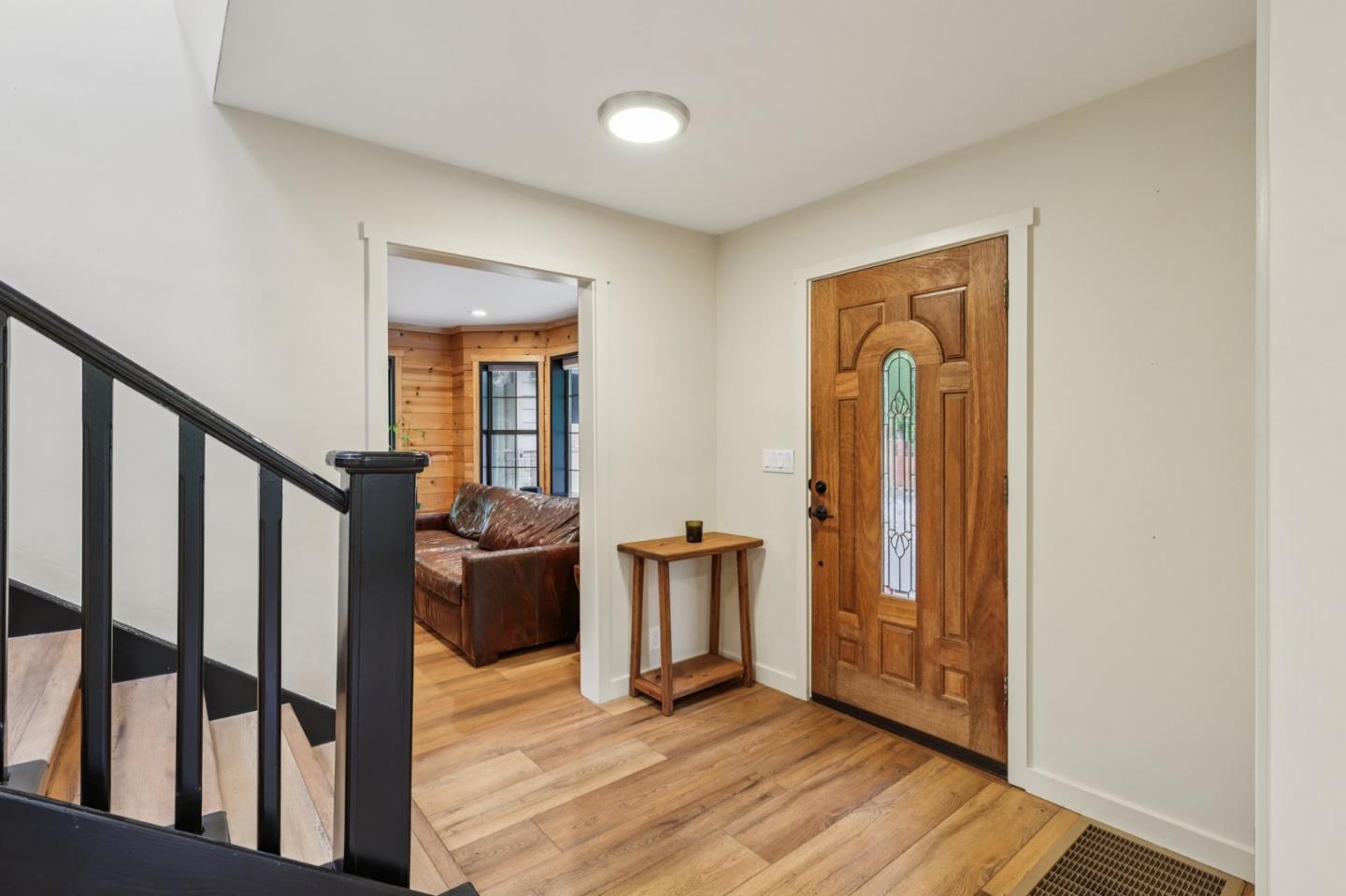 17386 Tressel Pass Road Boulder Creek, CA 95006 - Photo 3 of 41 a view of a hallway with wooden floor and staircase