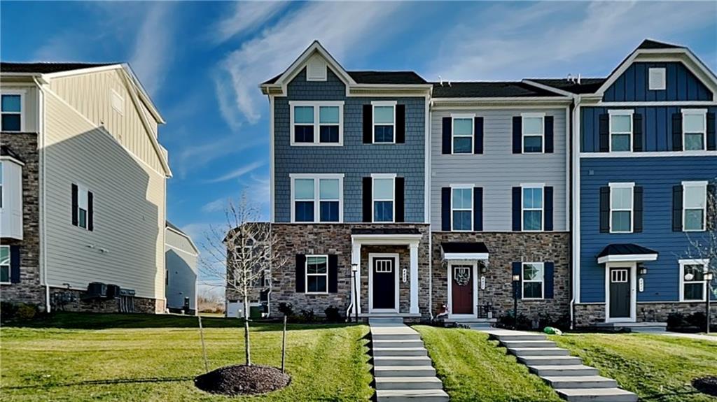 4408 Spruce Road Gibsonia, PA 15044 - Photo 1 of 40 a front view of a residential apartment building with a yard