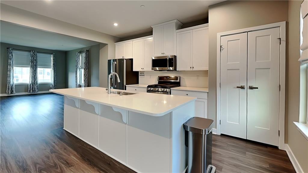 4408 Spruce Road Gibsonia, PA 15044 - Photo 13 of 40 a kitchen with kitchen island a sink a stove and refrigerator