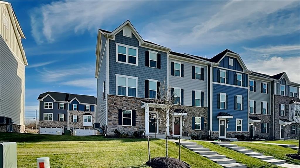 4408 Spruce Road Gibsonia, PA 15044 - Photo 2 of 40 a front view of residential houses with yard and swimming pool