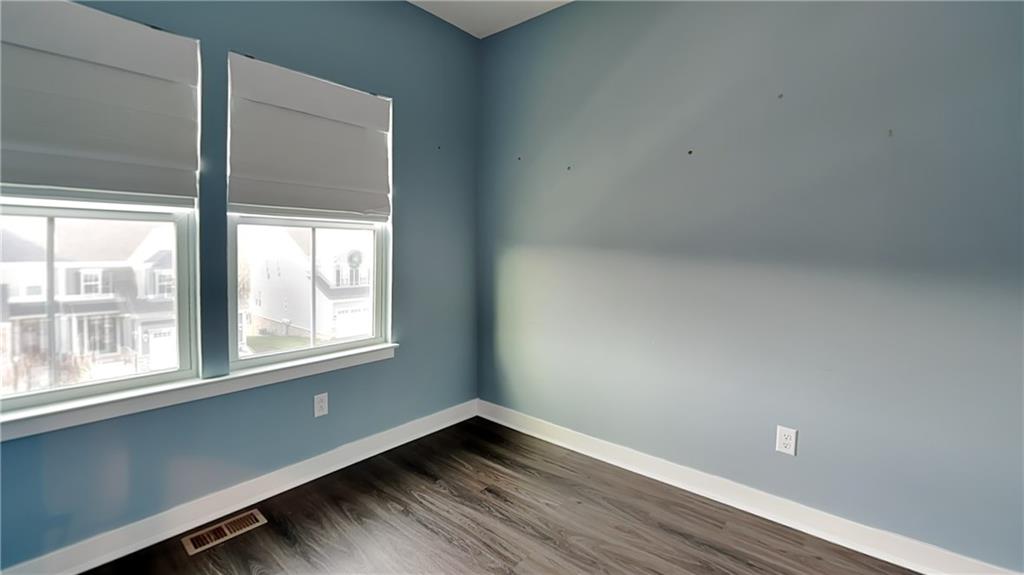 4408 Spruce Road Gibsonia, PA 15044 - Photo 34 of 40 an empty room with wooden floor and windows
