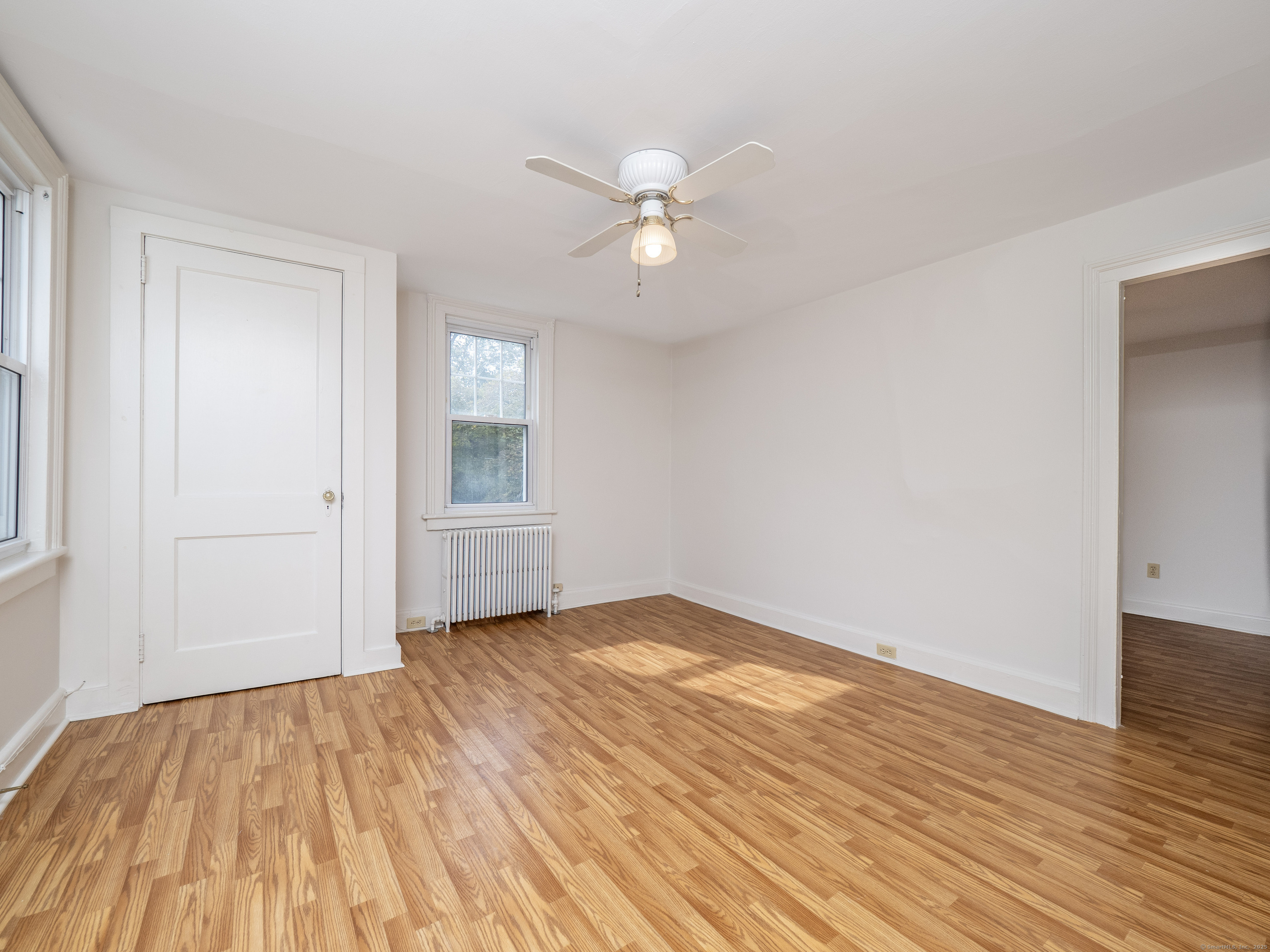 35 Ramapoo Road Ridgefield, CT 06877 - Photo 15 of 38 a view of an empty room with wooden floor and a window