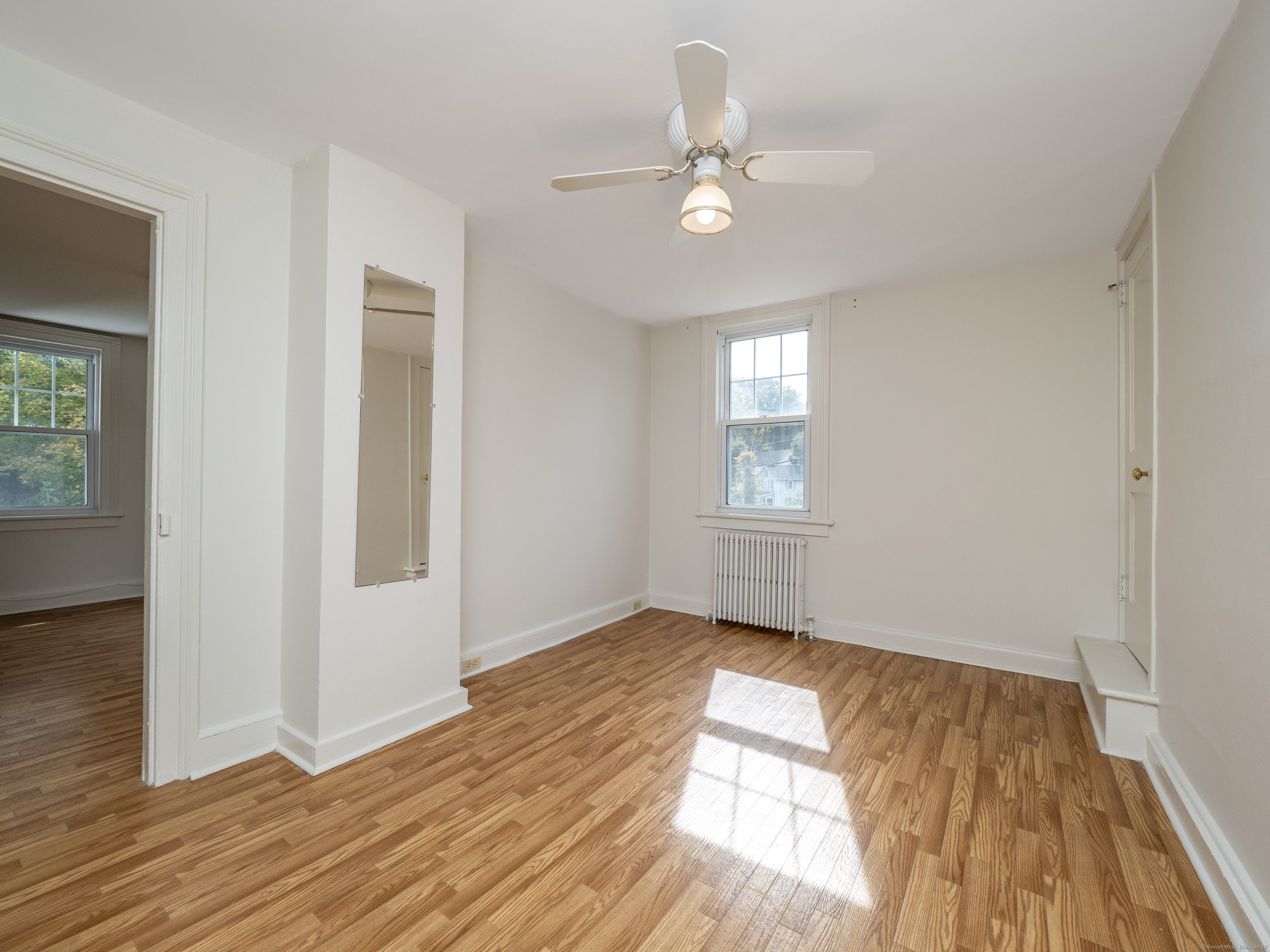 35 Ramapoo Road Ridgefield, CT 06877 - Photo 17 of 38 an empty room with wooden floor fan and windows