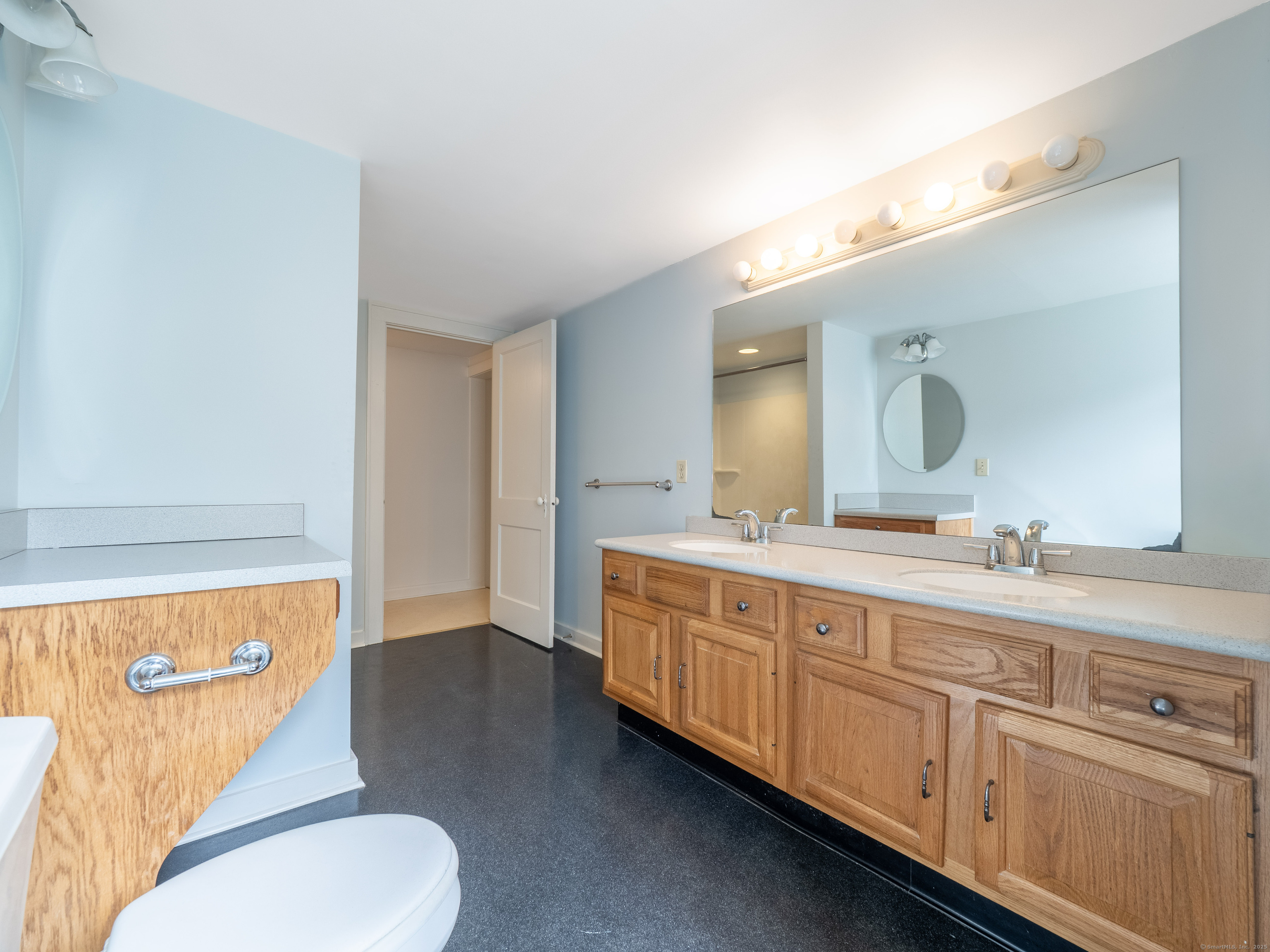 35 Ramapoo Road Ridgefield, CT 06877 - Photo 19 of 38 a spacious bathroom with a double vanity sink and a mirror