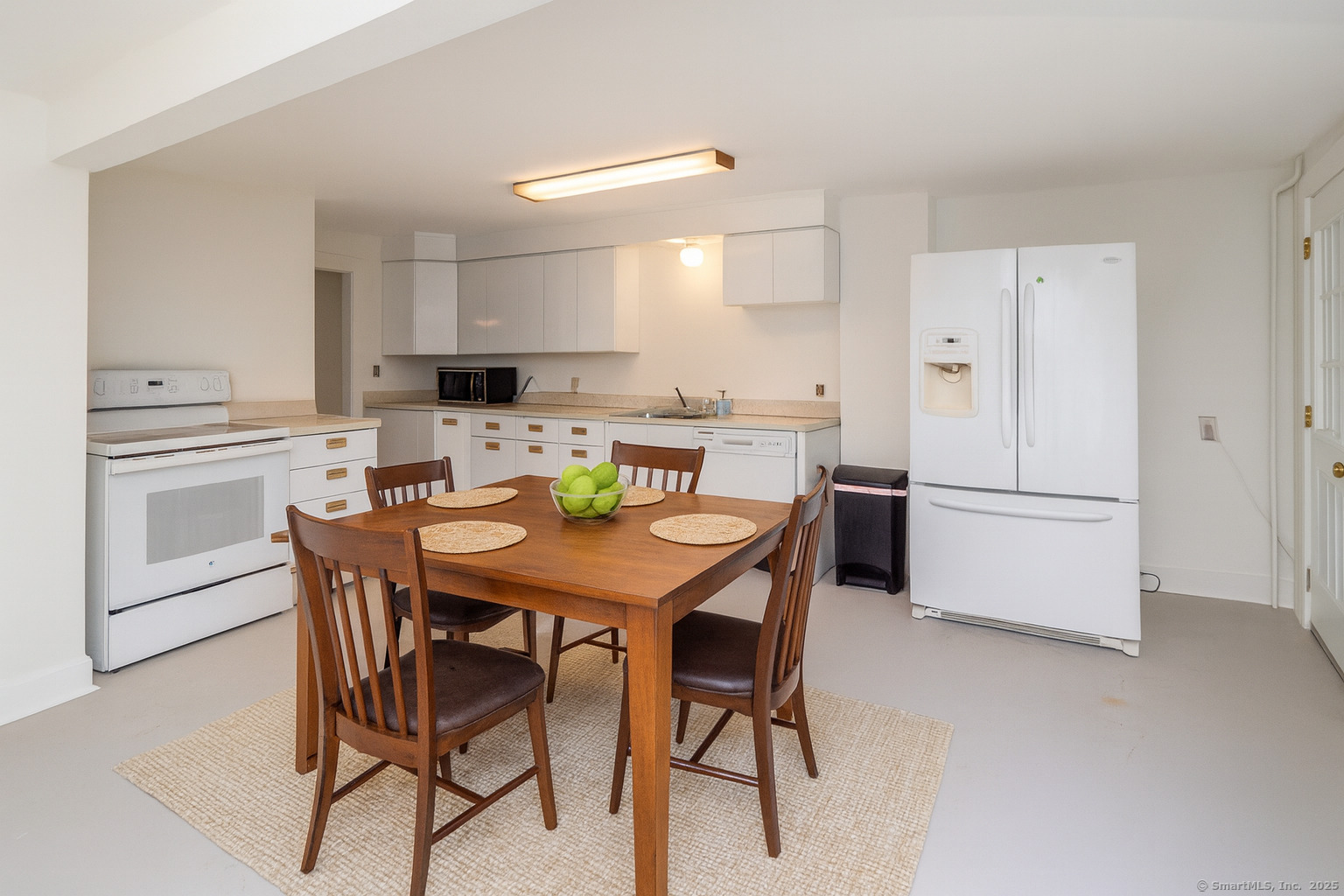 35 Ramapoo Road Ridgefield, CT 06877 - Photo 27 of 38 a kitchen with a dining table chairs and refrigerator