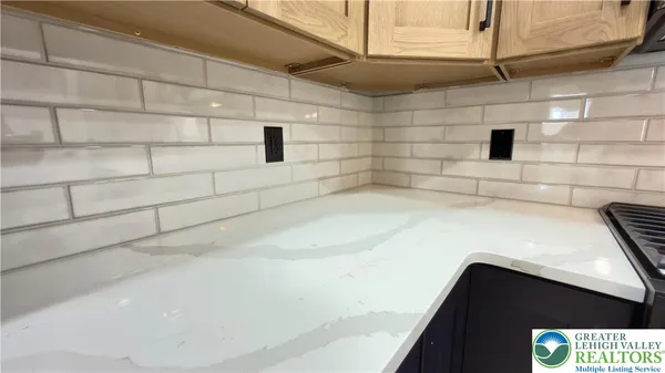 a view of kitchen with granite countertop cabinets and wooden floor