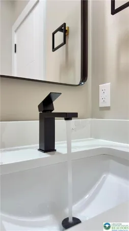 a view of bathroom with a sink and mirror