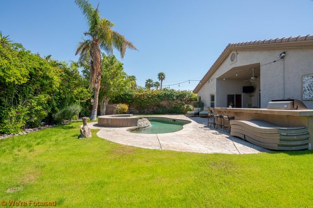 a view of a backyard with a patio and plants
