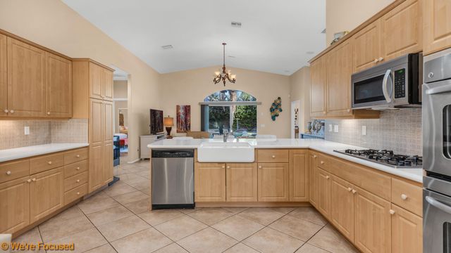 a kitchen with stainless steel appliances kitchen island granite countertop a sink and cabinets