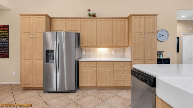a kitchen with stainless steel appliances granite countertop a refrigerator sink and cabinets