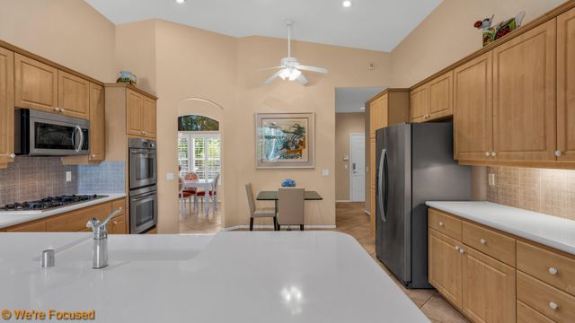 a kitchen with stainless steel appliances a refrigerator sink and microwave
