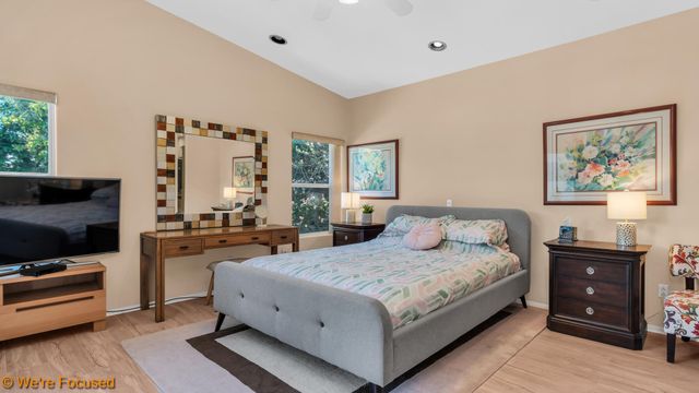 a bedroom with a large bed and a flat screen tv