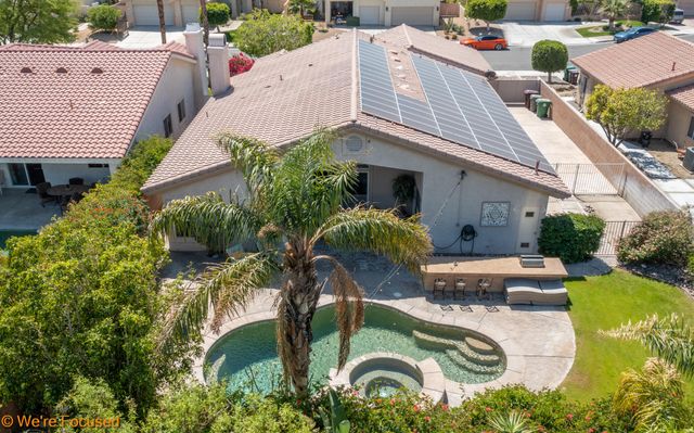 an aerial view of a house with outdoor space and sitting area