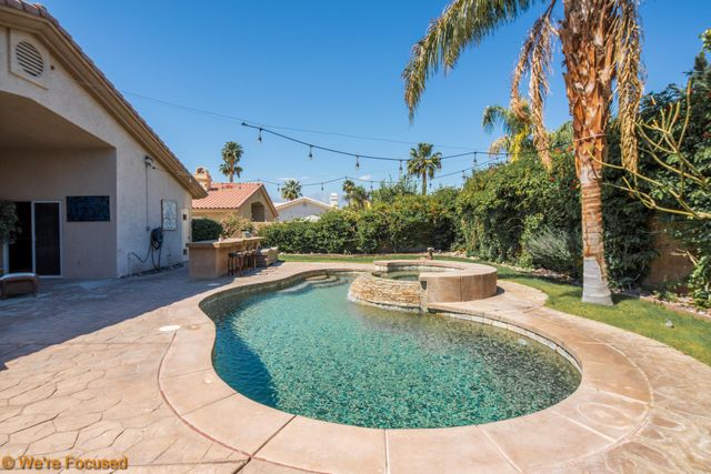 a view of a swimming pool with a patio