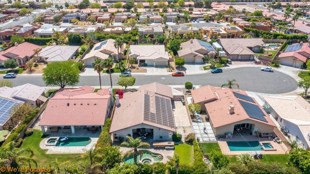 an aerial view of residential houses with yard