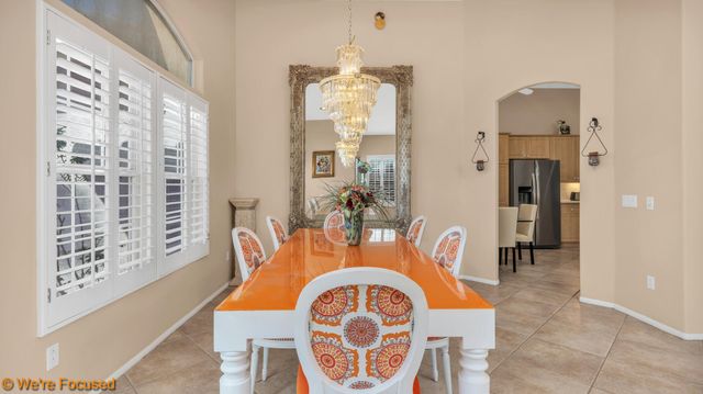 a dining room with furniture and a chandelier
