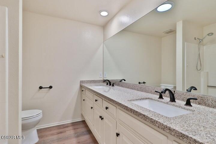 2379 Welcome Court Simi Valley, CA 93063 - Photo 29 of 49 a bathroom with a granite countertop sink and a mirror