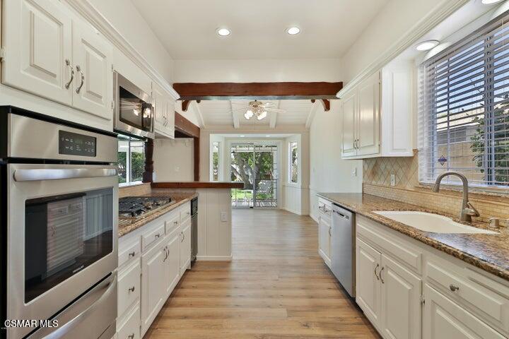2379 Welcome Court Simi Valley, CA 93063 - Photo 3 of 49 a large kitchen with stainless steel appliances granite countertop a stove and a sink