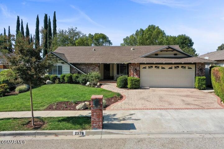 2379 Welcome Court Simi Valley, CA 93063 - Photo 8 of 49 a front view of a house with a yard and trees