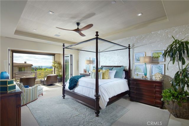 a bedroom with a large bed and a potted plant