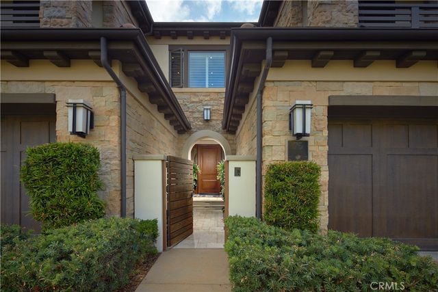 a front view of a house with plants