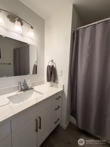 a bathroom with a double vanity sink and mirror