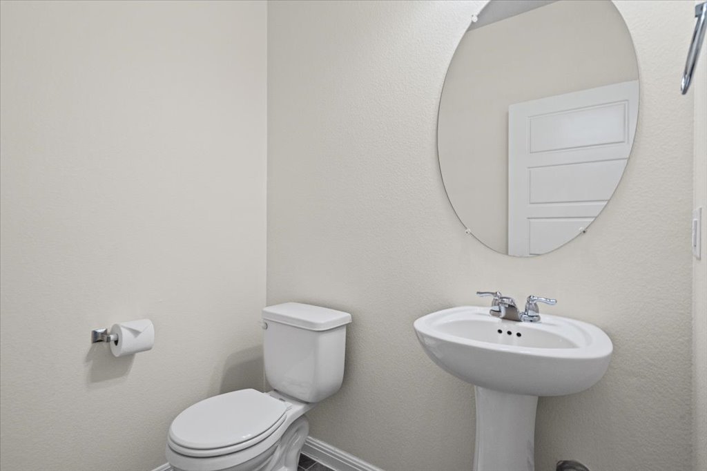 1502 Airedale Road, Unit 2502 Austin, TX 78748 - Photo 14 of 28 A compact and functional powder room with a pedestal sink and simple toilet awaits.