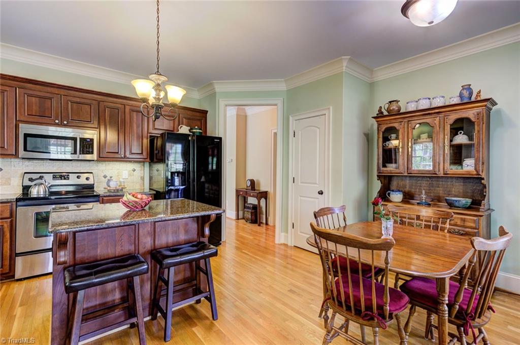 5909 Ballinger Road, Unit D Greensboro, NC 27410 - Photo 11 of 30 Kitchen island with breakfast bar seating.