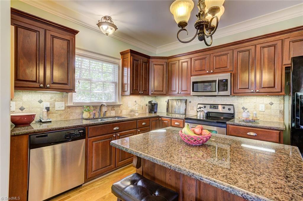 5909 Ballinger Road, Unit D Greensboro, NC 27410 - Photo 12 of 30 Stainless steel appliances, tile backsplash.