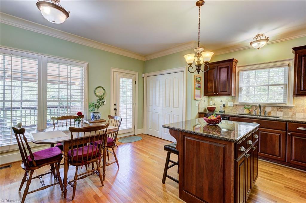 5909 Ballinger Road, Unit D Greensboro, NC 27410 - Photo 10 of 30 Kitchen and informal breakfast area receive lots of natural light.