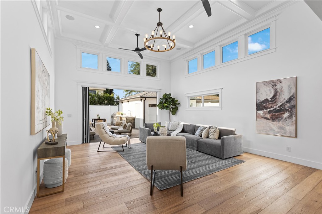 12947 La Maida Street Sherman Oaks, CA 91423 - Photo 3 of 31 a living room with furniture a chandelier a fireplace and a large window