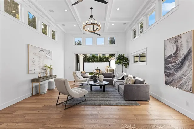 a living room with fireplace furniture and a large window