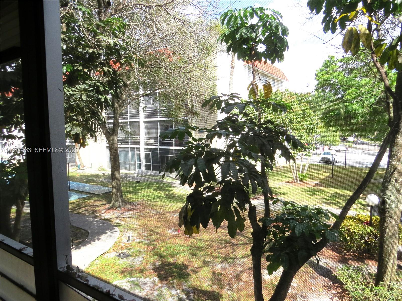 3591 Inverrary Drive, Unit 203 Lauderhill, FL 33319 - Photo 11 of 12 a view of a yard with a tree