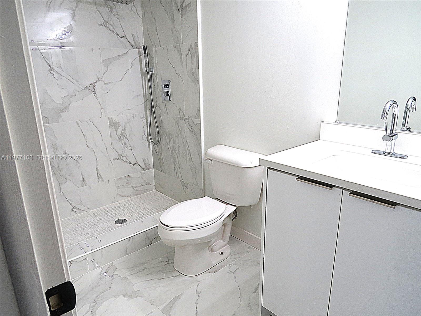 3591 Inverrary Drive, Unit 203 Lauderhill, FL 33319 - Photo 4 of 12 a bathroom with a sink toilet and shower