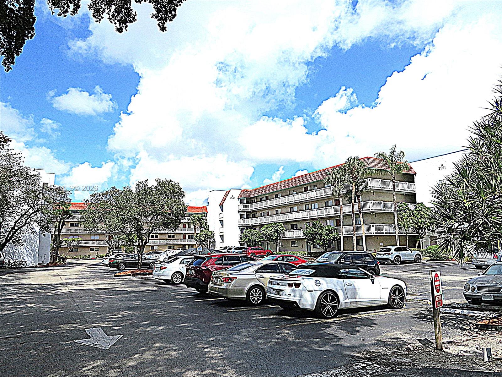 3591 Inverrary Drive, Unit 203 Lauderhill, FL 33319 - Photo 8 of 12 a car parked in front of a building