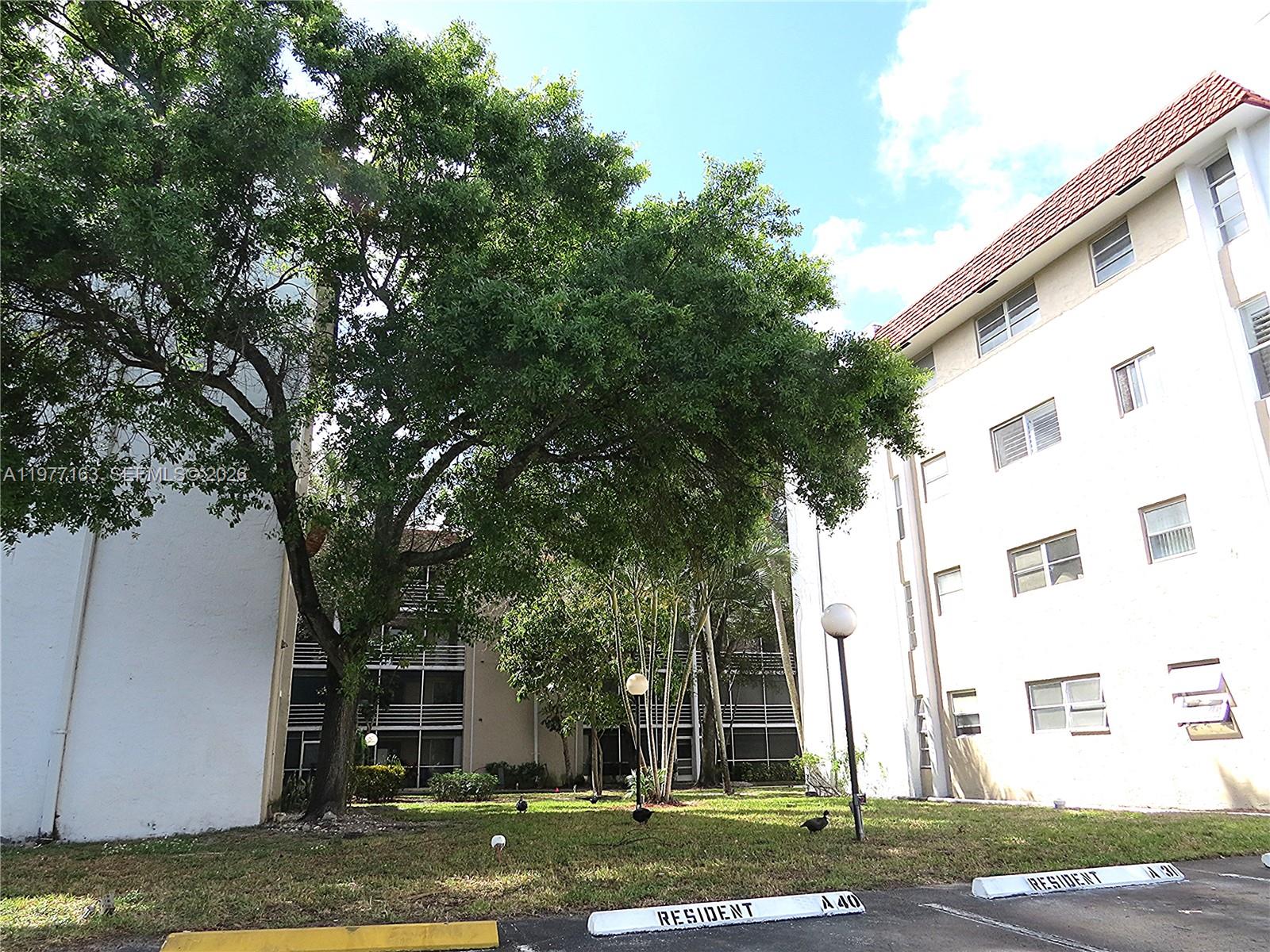 3591 Inverrary Drive, Unit 203 Lauderhill, FL 33319 - Photo 10 of 12 a view of a house with a yard
