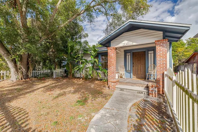 a view of a house with a yard and sitting area