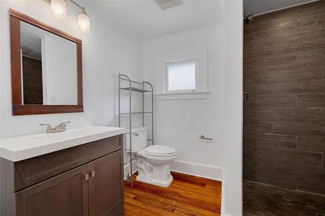 a bathroom with a sink a toilet and mirror