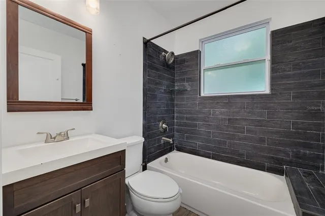 a bathroom with a sink a toilet and bathtub