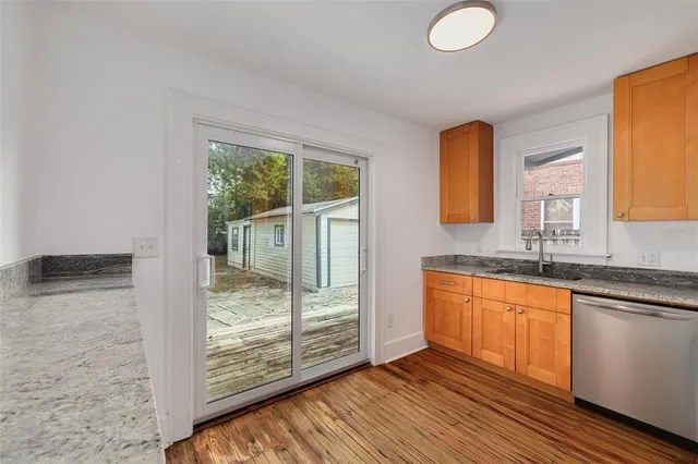 a view of bathroom with window and hardwood floor