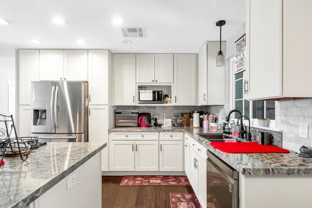 a kitchen that has a lot of cabinets and refrigerator