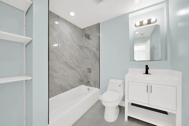 a bathroom with a toilet sink and a mirror