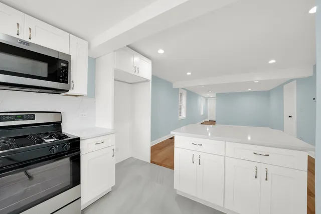a kitchen with a sink stainless steel appliances and cabinets