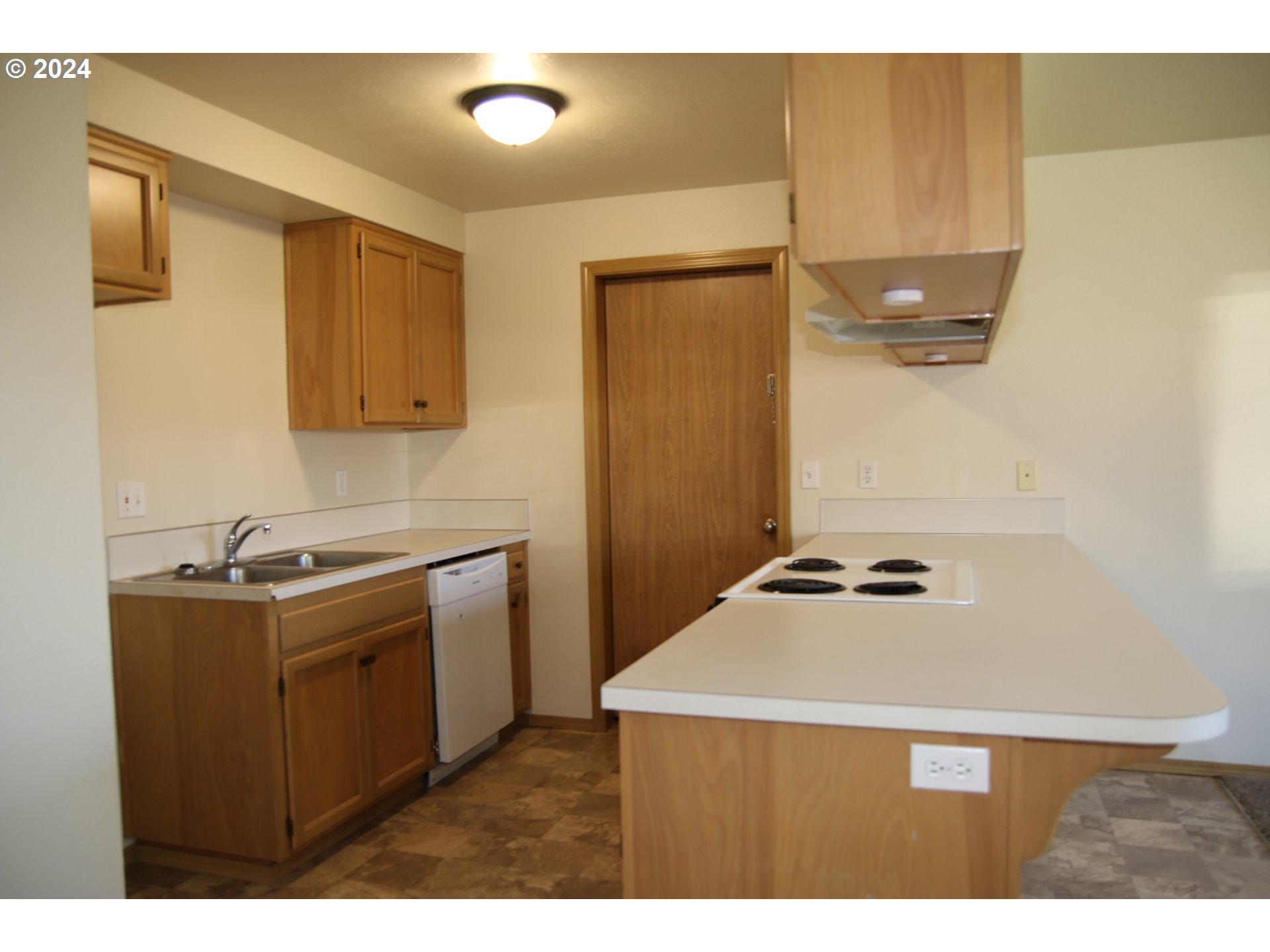 452 Olson Drive Jefferson, OR 97352 - Photo 6 of 17 a kitchen with kitchen island a sink stove and refrigerator
