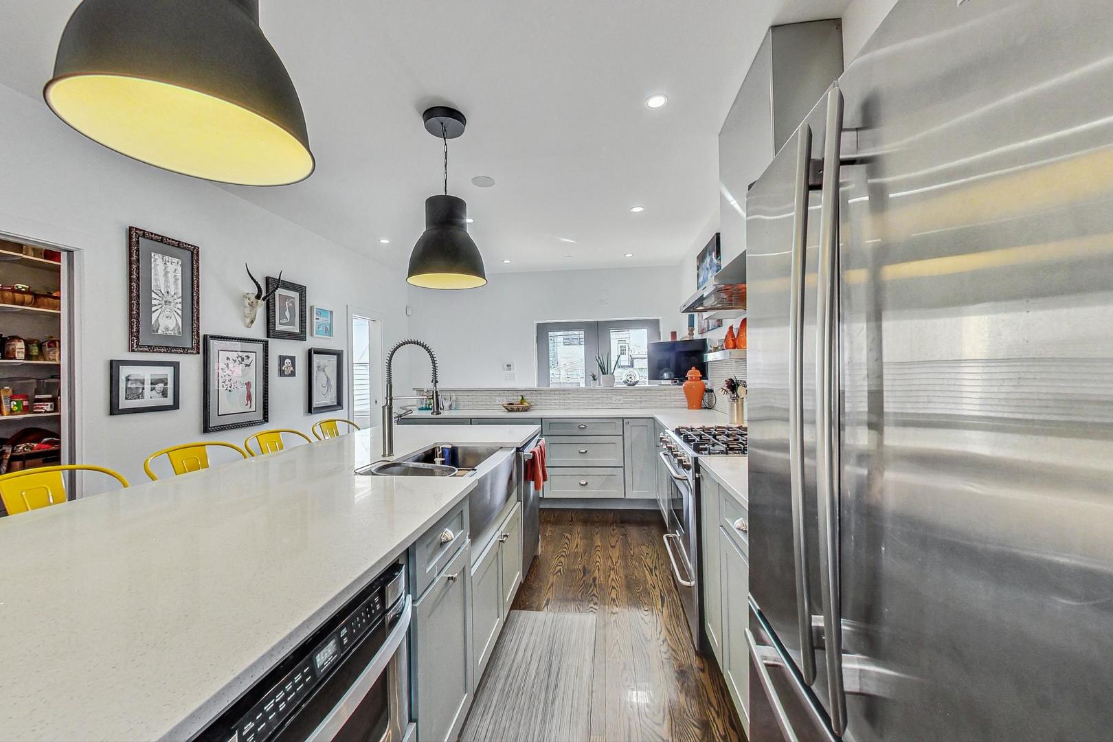2445 West Rice Street Chicago, IL 60622 - Photo 11 of 46 a kitchen with stainless steel appliances granite countertop a sink and cabinets